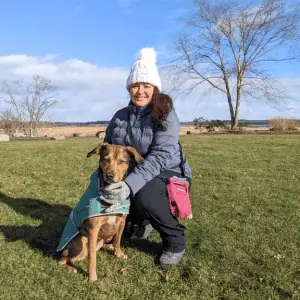 Founder of Shoreline Happy Paws, Adriana Valle with a dog in a park - Become a Shoreline Happy Paws Dog Walker