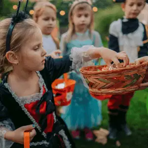 child in costume getting candy on halloween in Old Saybrook, CT