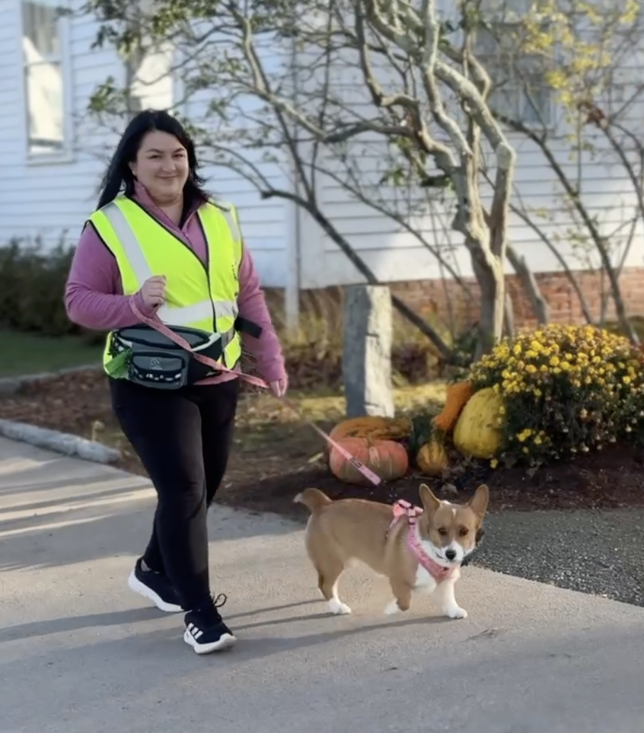 Adriana walking her corgi Cannoli in her Shoreline Happy Paws vest